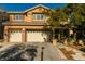 Two-story house with three-car garage, landscaping, and a large tree in the front yard at 10744 Balsam Creek Ave, Las Vegas, NV 89144