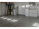 Garage with epoxy flooring, water softener, and storage at 10744 Balsam Creek Ave, Las Vegas, NV 89144