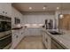 Modern kitchen with white cabinets, granite countertops, and stainless steel appliances at 10744 Balsam Creek Ave, Las Vegas, NV 89144