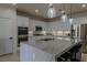 Modern kitchen with stainless steel appliances, white cabinets, and a large island at 10744 Balsam Creek Ave, Las Vegas, NV 89144