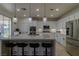 Modern kitchen with stainless steel appliances, white cabinets, and a large island at 10744 Balsam Creek Ave, Las Vegas, NV 89144