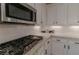 Modern kitchen with stainless steel appliances and white cabinets at 10744 Balsam Creek Ave, Las Vegas, NV 89144