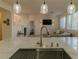 Kitchen features a large island with seating and a stainless steel sink at 10744 Balsam Creek Ave, Las Vegas, NV 89144