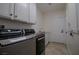 Convenient laundry room with washer, dryer, cabinets and sink at 10744 Balsam Creek Ave, Las Vegas, NV 89144