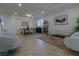 Bright living room features tile floors, comfy seating, and a large window at 10744 Balsam Creek Ave, Las Vegas, NV 89144