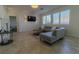 Spacious living room with a gray sectional sofa and a fireplace at 10744 Balsam Creek Ave, Las Vegas, NV 89144