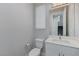 Modern powder room with white vanity and gray walls at 11377 Gravitation Dr # 0, Las Vegas, NV 89135