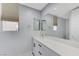 Modern bathroom with white vanity, large mirror, and gray walls at 11377 Gravitation Dr, Las Vegas, NV 89135