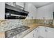 Modern kitchen with gas cooktop and range hood at 11377 Gravitation Dr, Las Vegas, NV 89135