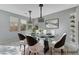 Light-filled dining room with glass table, modern lighting, and stylish decor with backyard view at 11377 Gravitation Dr, Las Vegas, NV 89135