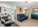 Living room features leather furniture and a view into kitchen at 1215 Ferguson Ave, North Las Vegas, NV 89030