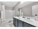 Modern bathroom featuring double sinks, framed mirror, white marble floors and shower-tub combination at 12815 Alcores St, Las Vegas, NV 89141