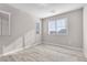 Bright bedroom featuring hardwood floors, neutral walls, and three well-lit windows at 12815 Alcores St, Las Vegas, NV 89141