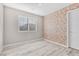 Bedroom with light walls, light floors and a wallpaper accent wall at 12815 Alcores St, Las Vegas, NV 89141