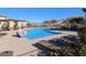 Community pool featuring plenty of lounge chairs and mountain views in the background at 12815 Alcores St, Las Vegas, NV 89141