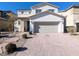 Two-story house with attached garage and brick driveway at 12815 Alcores St, Las Vegas, NV 89141