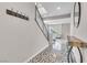 Hallway with geometric tile, wooden console table, and staircase with iron railing at 12815 Alcores St, Las Vegas, NV 89141