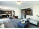 Open living room with kitchen and dining area, featuring hardwood floors and modern chandelier at 12815 Alcores St, Las Vegas, NV 89141