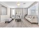 Bright living room features wood floors, elegant furniture and a decorative fireplace at 12815 Alcores St, Las Vegas, NV 89141