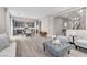 Open-concept living area with wood floors connecting to the kitchen and staircase at 12815 Alcores St, Las Vegas, NV 89141