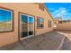 Backyard view of house with sliding glass door and small patio at 1282 Paseo Del Oso Ln, Henderson, NV 89002