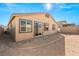 Tan house exterior and backyard view with gravel and block wall at 1282 Paseo Del Oso Ln, Henderson, NV 89002