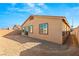 Tan house exterior with backyard, gravel ground, and block wall at 1282 Paseo Del Oso Ln, Henderson, NV 89002