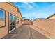 House backyard with gravel ground, block wall, and sliding glass door access at 1282 Paseo Del Oso Ln, Henderson, NV 89002