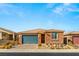 Single-story home with stone and neutral siding, a two-car garage, and desert landscaping at 1282 Paseo Del Oso Ln, Henderson, NV 89002