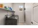 Laundry room with washer, dryer, and shelving unit at 1282 Paseo Del Oso Ln, Henderson, NV 89002