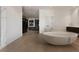 Modern bathroom featuring a large soaking tub, custom shelves, and sleek fixtures at 14 Magic Stone Ln, Las Vegas, NV 89135