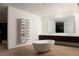 Bright bathroom featuring a soaking tub, modern vanity, and custom shelves at 14 Magic Stone Ln, Las Vegas, NV 89135