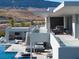 Modern home showcasing outdoor living spaces, a pool, and mountain views from the expansive rooftop terrace at 14 Magic Stone Ln, Las Vegas, NV 89135