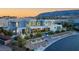 Aerial view of a modern gray home with desert landscaping, mountains in background at 14 Magic Stone Ln, Las Vegas, NV 89135