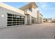 Modern home showcasing a spacious four-car garage with sleek glass doors and contemporary exterior design at 14 Magic Stone Ln, Las Vegas, NV 89135