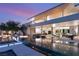 Incredible outdoor living area with an infinity pool, sleek furniture, and ambient lighting at 14 Magic Stone Ln, Las Vegas, NV 89135