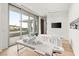 Bright treatment room with hardwood floors and large sliders to the balcony at 14 Magic Stone Ln, Las Vegas, NV 89135