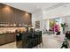 Contemporary wet bar featuring dark wood accents and bar seating, situated adjacent to a stylish living area at 14 Magic Stone Ln, Las Vegas, NV 89135