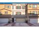 Tan three-story townhouse with two-car garage and landscaping at 1525 Spiced Wine Ave # 23103, Henderson, NV 89074