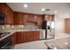 Kitchen with stainless steel appliances and wood cabinetry at 1525 Spiced Wine Ave # 23103, Henderson, NV 89074