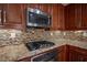 Gas cooktop and microwave in a kitchen with granite counters at 1525 Spiced Wine Ave # 23103, Henderson, NV 89074