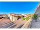 Elevated view of backyard, showing a home with solar panels and a covered patio at 1664 Hartley Ave, Henderson, NV 89052