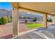 Covered patio overlooking a landscaped backyard with artificial turf at 1664 Hartley Ave, Henderson, NV 89052