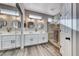 Elegant bathroom with double vanity, large mirror, and a walk-in shower at 1664 Hartley Ave, Henderson, NV 89052