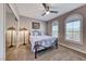 Well-lit bedroom with ceiling fan and arched windows at 1664 Hartley Ave, Henderson, NV 89052