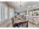 Kitchen and dining area with light wood floors and a modern chandelier at 1664 Hartley Ave, Henderson, NV 89052