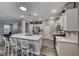 Open kitchen with island, white cabinets and quartz countertops at 1664 Hartley Ave, Henderson, NV 89052