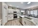 Updated kitchen featuring white cabinets, quartz countertops, and stainless steel appliances at 1664 Hartley Ave, Henderson, NV 89052