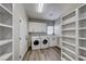 Laundry room with washer, dryer, and built-in shelving at 1664 Hartley Ave, Henderson, NV 89052