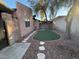 Artificial turf and stone pathway backyard at 1804 Discus Dr, Las Vegas, NV 89108